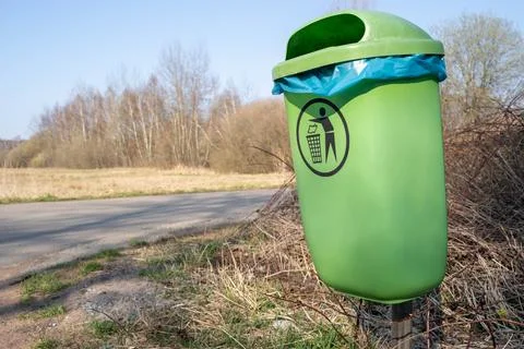 Green garbage can in the park Stock Photos