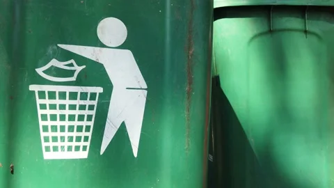 Green Garbage Plastic Bins with Sunlight Beam and Flying Flies, Suitable for Env Stock Footage 134010531