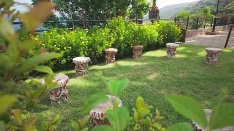 Green Garden with Rustic Stools Yellow Flowers Overlooking Mediterranean Sea Stock Footage 341364496