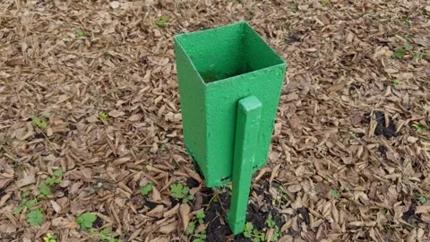A Green Gardening Tool Positioned Within a Beautifully Mulched Landscape Stock Footage 305279629