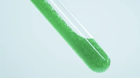 Green gel with air bubbles flows into a glass tube. Stock Footage 242805521