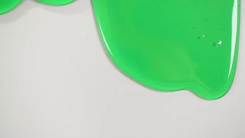 Green gel fluid on gray background. Video stock 266648987