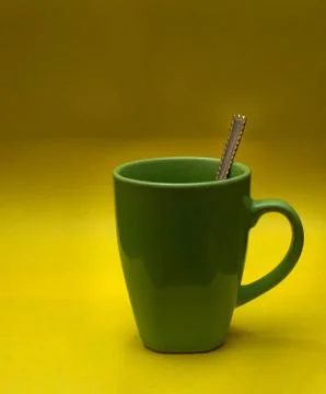 Green glass and spoon Stock Photos