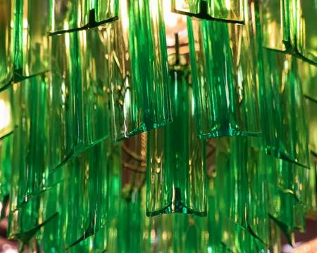 Green glass elements creating a striking mid century modern chandelier desi.. 스톡 사진