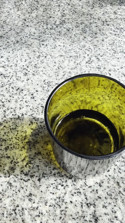 Green glass with water on marble table vertical Stock Footage 329095753