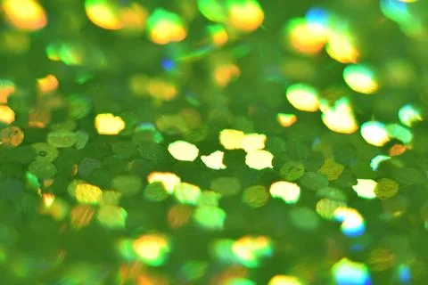 Green glitter, blurred effect. Glowing holiday light circles are created fr.. Stock Photos