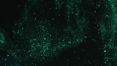 Green glitter particles floating abstract black background. Magic sequins fly. 動画素材 282511490