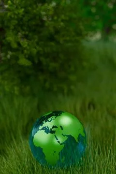 A green globe rests on grass, symbolizing Earth Day Illustrazione stock