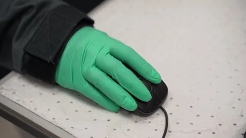 A Green Gloved Hand Engaging with a Computer Mouse for Efficient Task Management Video stock 300489420