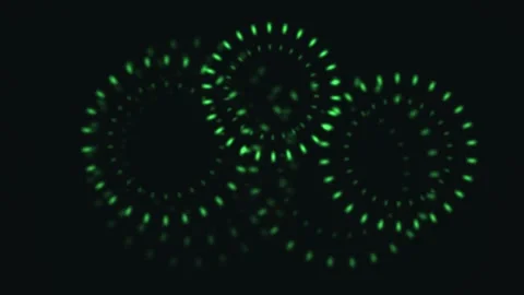Green glowing circles create dynamic motion in dark Stock Footage 338230898