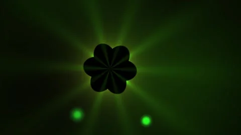 Green glowing clover leaf with light beams on dark background. Stock Footage 337475197