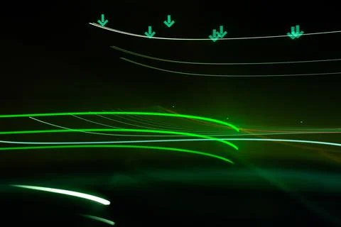 Green glowing light waves on dark technology background Stock Photos