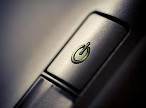 Green glowing power button Closeup shot Stock Photos
