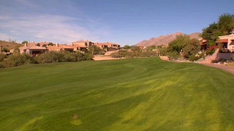Green golf course mountains in background Stock Footage 125278500
