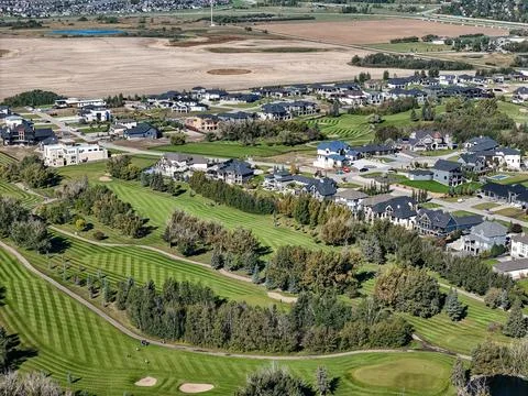 Green golf course snakes between elegant homes in Saskatoon Stock Photos