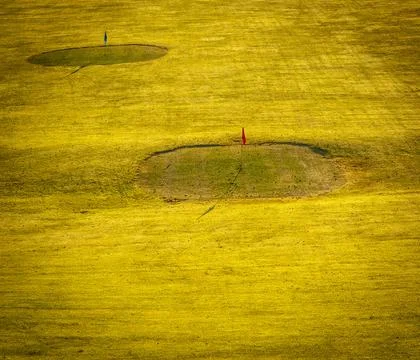 The green on the golf course at sunset. Stock Photos