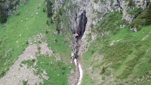 Green gorge. Beautiful cliffs and mountains. Runs a small waterfall and a river. Video stock 100770033