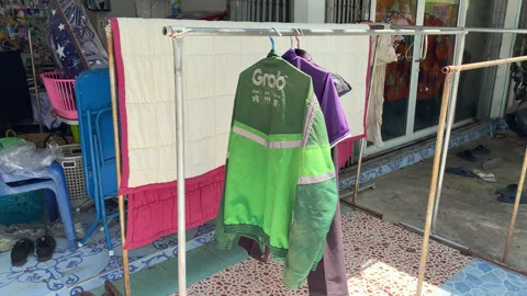 Green Grab Jacket Uniform Hang Dry On Clothes Line In The Sun After Cleaned Stock Footage 247433072