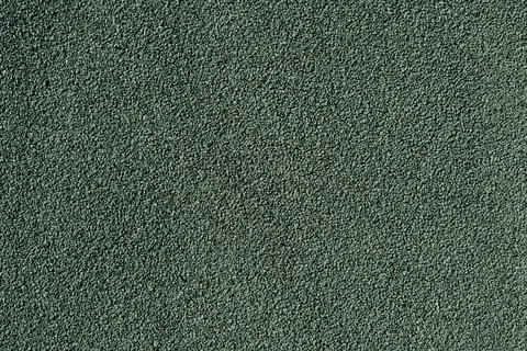 Green granular texture background of a flat rubber mat or asphalt pavement Stock Photos