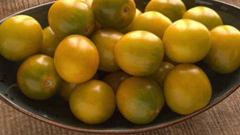 Green grape cherry tomatoes heap rotating smoothly on oval blue platter. Stock Footage 342848514