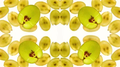 Green grape slices on a white background. Kaleidoscope. Rotation. Video stock 217010189