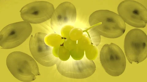 Green grape on a yellow background. Rays of light. Video stock 217009305