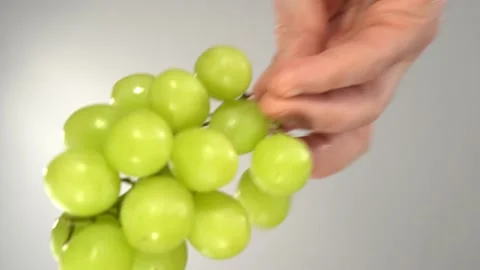 Green grapes fall on the glass surface, bottom view. Stock Footage 172292239