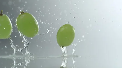 Green grapes falling and bouncing on water surface. Slow Motion. Stock Footage 50508266