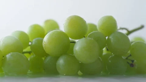 Green grapes falling on water surface. Slow Motion. Stock Footage 79477644