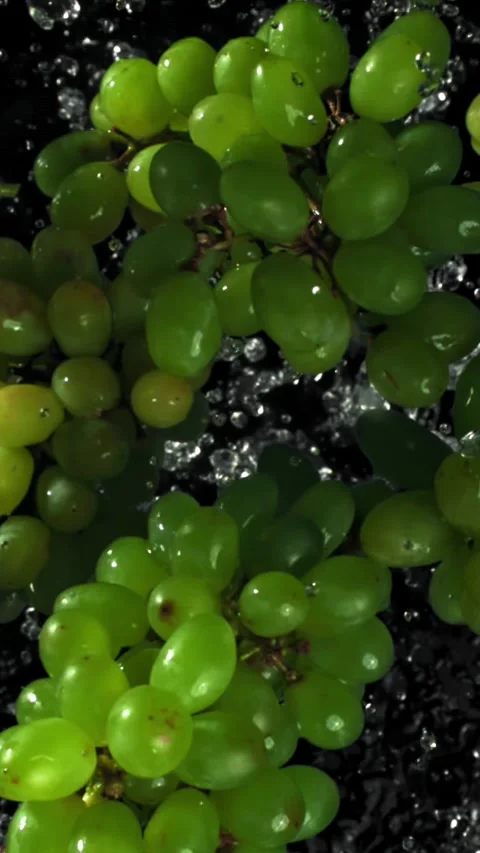 Green grapes fly up and fall down. Filmed on a high-speed camera at 1000 fps Stock Footage 335379952