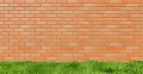 Green Grass on brick background Stock Photos
