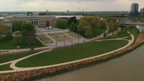 Green grass in oval shape by river's edge and steps leading up to park Stock Footage 131023735