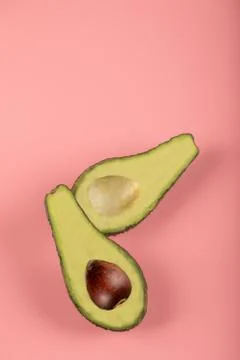 Green half avocadoes with and without seed Stock Photos