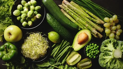 Green healthy food composition with avocado, broccoli, apple, smoothie... Stock Footage