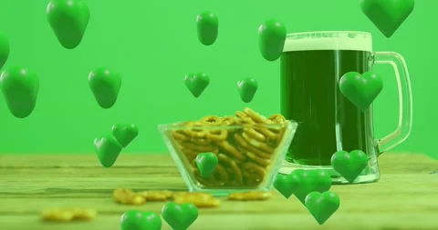 Green hearts appearing in first frames drifting to front passing pretzels, beer Stock Footage 329550527