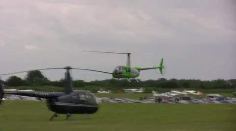 Green helicopter flying low over airfield Stock Footage 22934071