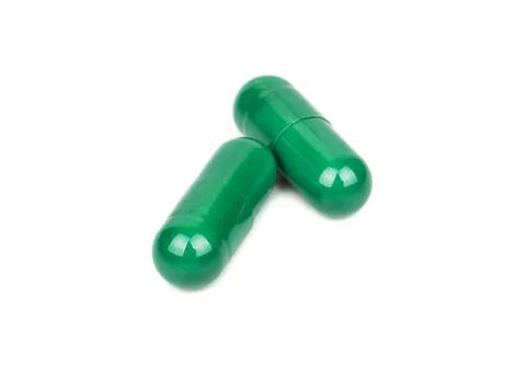 Green herbal capsule Stock Photos