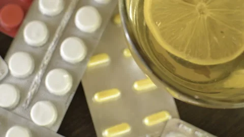 Green herbal tea with lemon. Tablets on the table. Epidemic flu. HD Видео 98400765