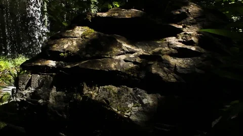 Green hidden magic waterfall in the middle of forest Stock Footage 112027102