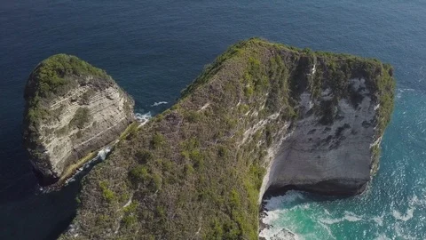 Green hill ridge with the blue waves underneath aerial footage Stock Footage 101667319