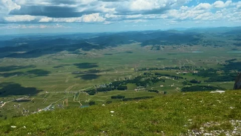 Green hill slopes with scattered white stones. Savin Kuk peak, Montenegro Видео 342978298
