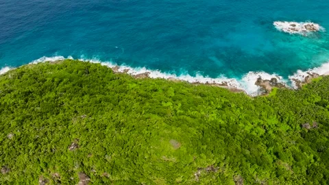 Green hills and the expansive ocean under a clear sky. Seychelles, Mahe. Stock Footage 303473053