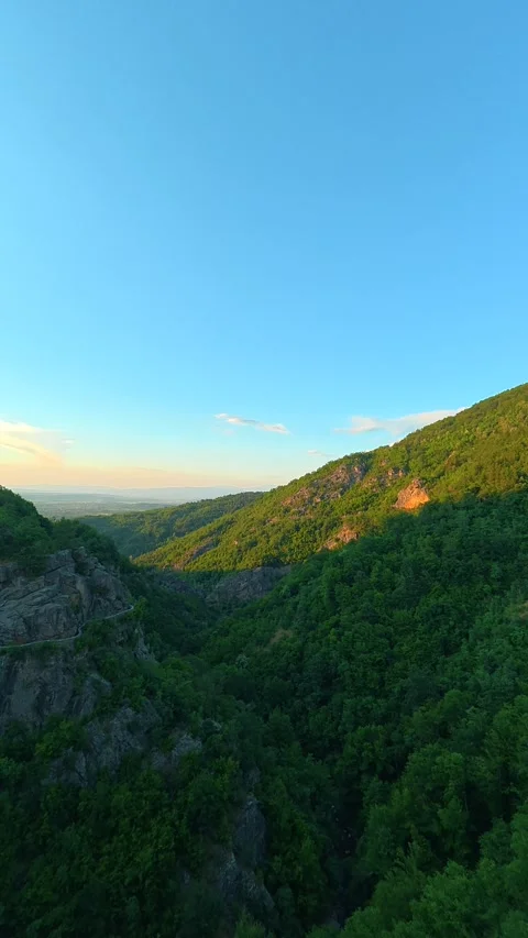 Green hills roll beneath a vast. Sokolica rock, Serbia. Vertical Stock Footage 341132613