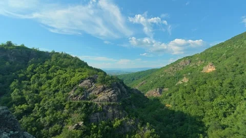Green hills roll under blue sky with wispy clouds. Vucjanka Canyon, Timelapse Stock Footage 341130135