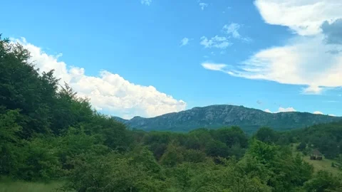 Green hills roll under a bright blue sky. Kozji Kamen area, Serbia 스톡 동영상 341876399