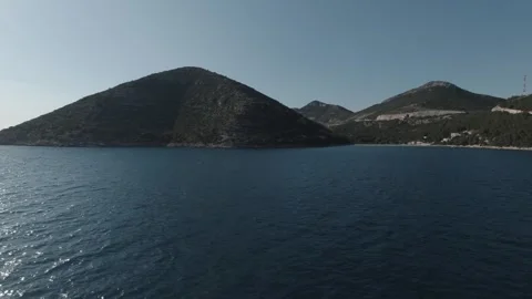 Green hills with seashore infront Stock Footage 242863773