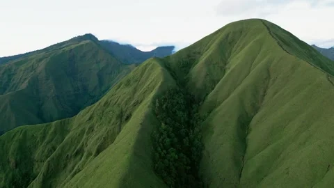 Green Hills with Sharp Ridge Line Under Soft Morning Light and Natural Shadows Stock Footage 336425135