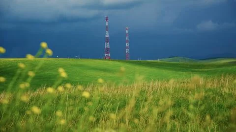 Green hills stretch under a brooding sky Stock Photos