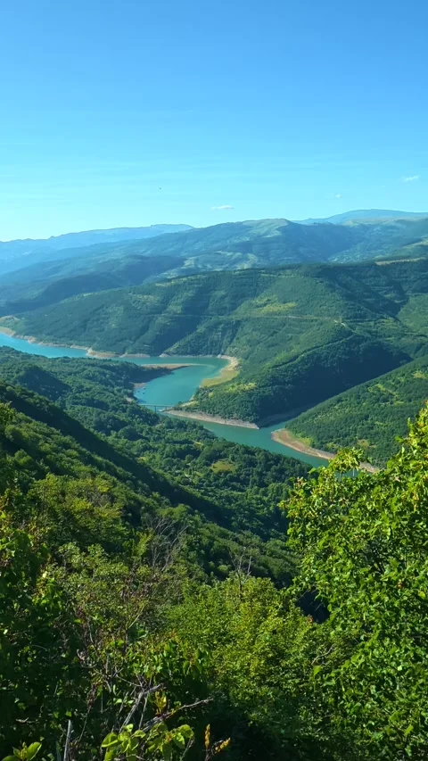 Green hills stretch under clear blue sky. Kozji Kamen viewpoint, Serbia Stock Footage 342343141