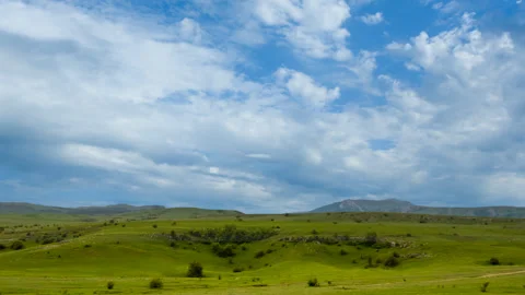 Green hills under a dense cloudy sky 動画素材 333671520